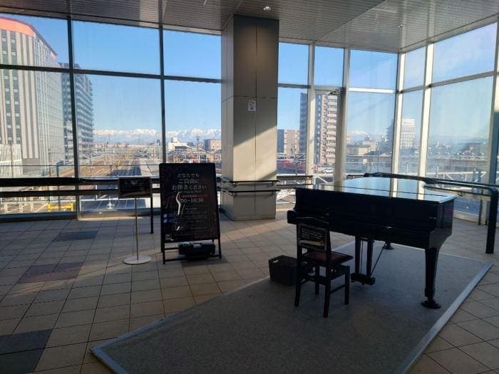 Photo of Takaoka Station Grand Street Piano at 末広町, 定塚町, 高岡市, 富山県, 933-0023, 日本. A public Yamaha grand piano in Takaoka Station's north–south free passage.…