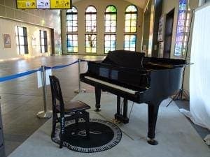 Photo of Sakado Station street piano at 〒350-0225 埼玉県坂戸市日の出町1番1号. A grand piano in the public station passage, set against the station's…