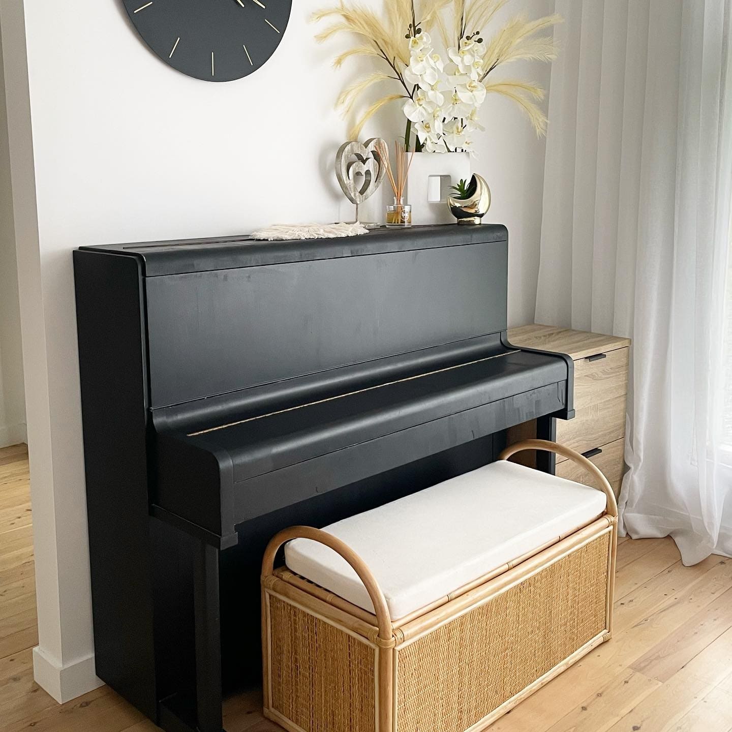 A black upright piano in a bright room near Manly Beach in Sydney