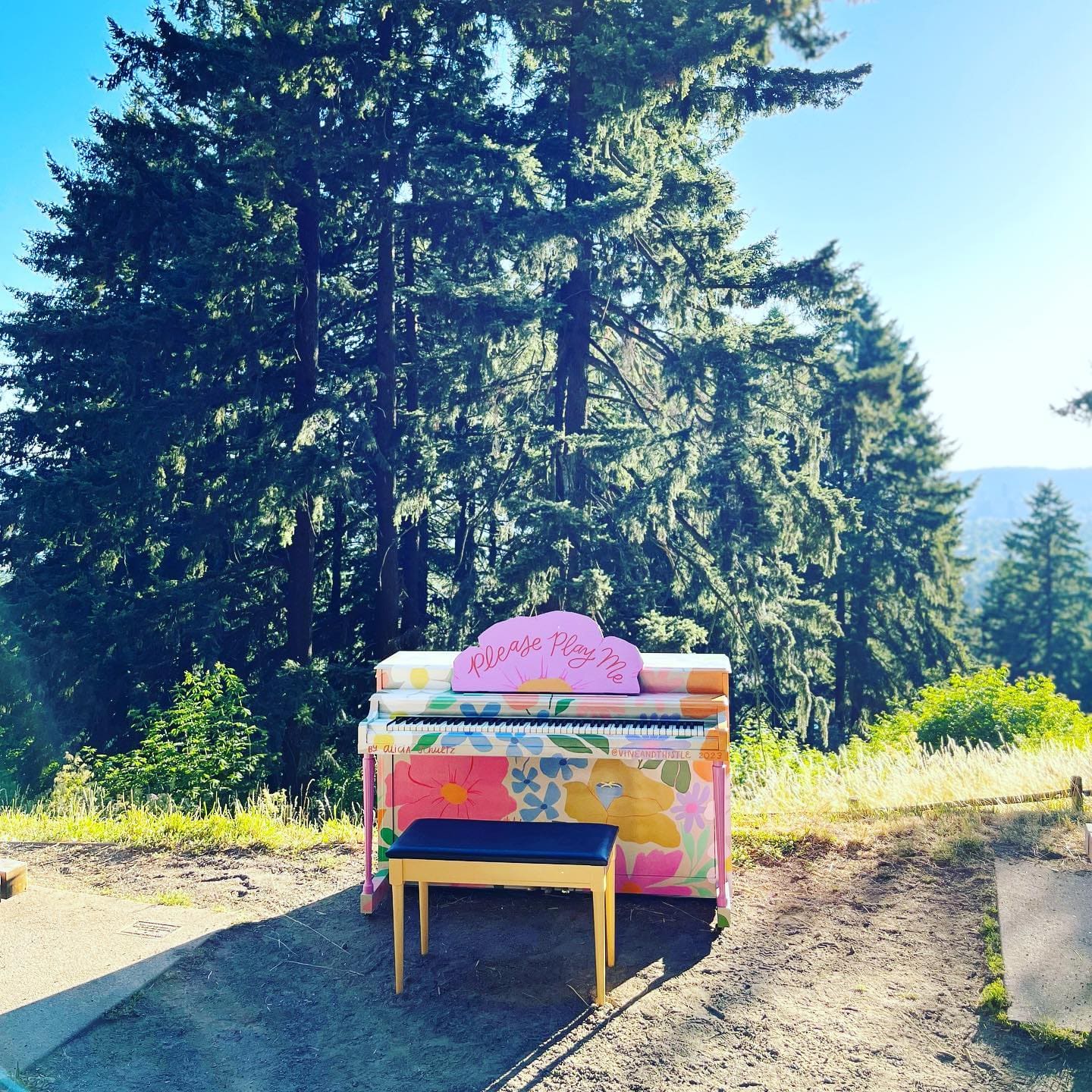 A colorful public piano beside a forested viewpoint at Mount Tabor