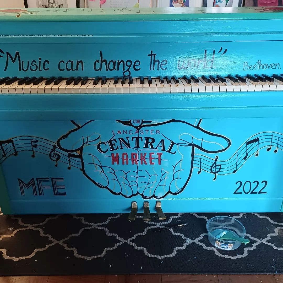 A turquoise public piano painted for Lancaster Central Market